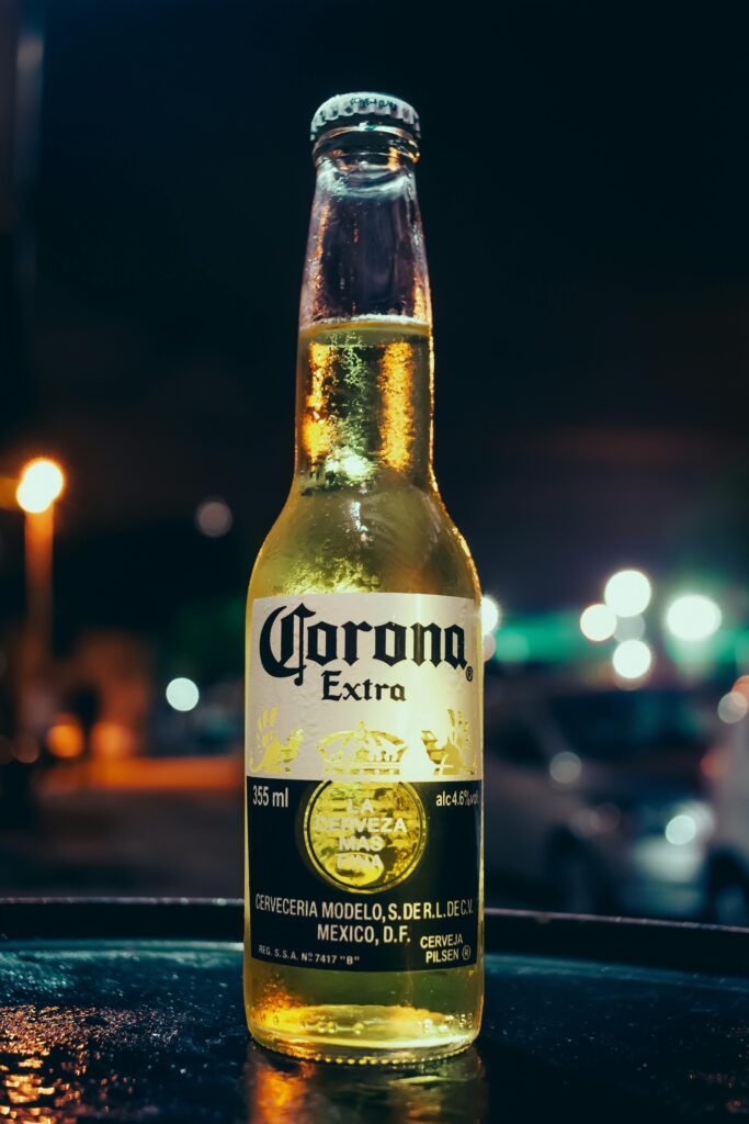 pexels-photo-2286972-2286972 A bottle of Corona beer stands illuminated against a blurred night city background, creating a vibrant urban atmosphere.